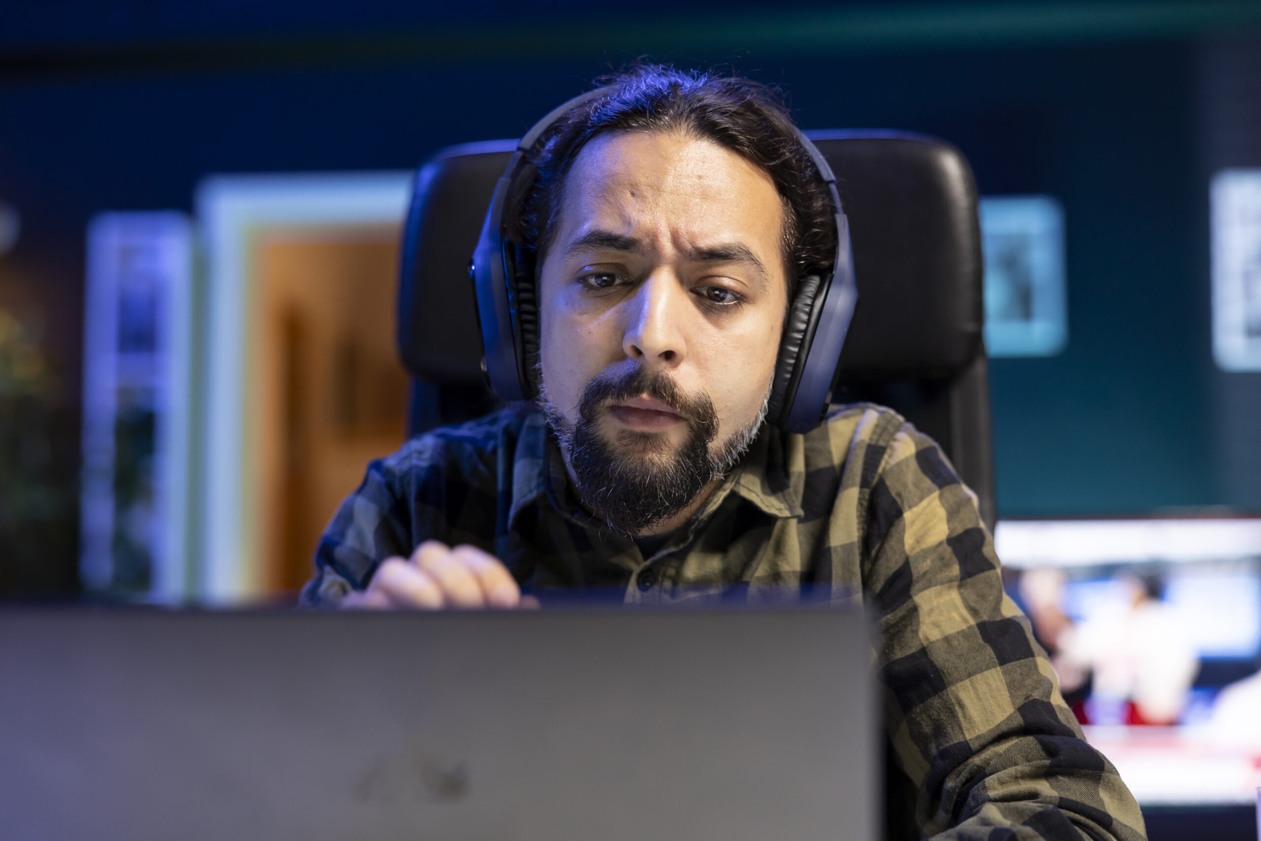 Man with headphones looking at laptop